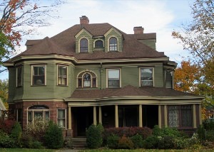 Дом фисташкового цвета с коричневой крышей
